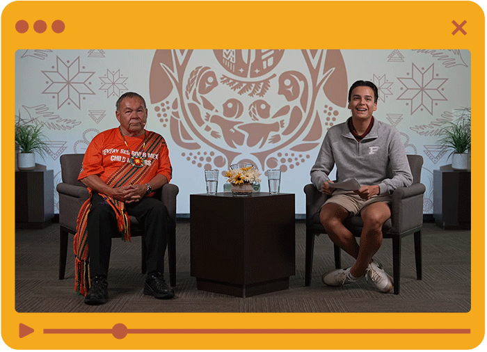 Speaker with student on stage